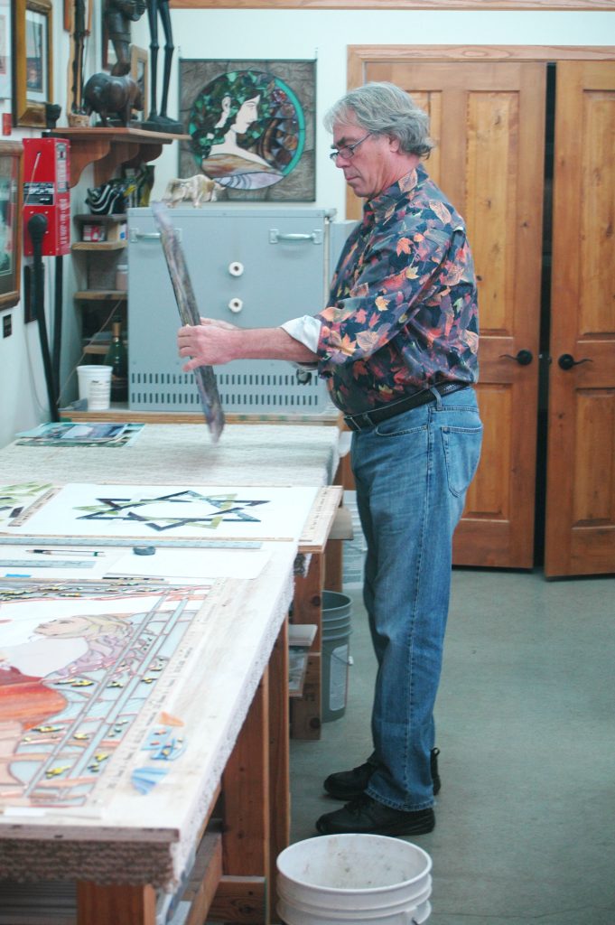 Photo by Don Lipps - Bob Vogel of Stained Glass Studio in St. Peter working on a project.