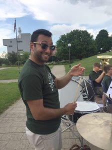 Scene from the 2017 MAYSO summer performance. Mark Wamma, strings director, professional musician and MAYSO alumnus helping out with percussion.