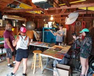 Photo by Kyle Zeiszler - Project Bike 2018 - Arist L'andrae Bradley welcomed us in to his garage studio where we talked about his Day of the Dead, meditation, and social justice influences. Also hard at work are filmmaker Austin Swain and photographer Maddie Fox.