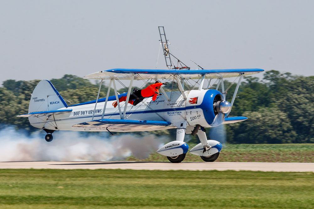 Photo by Rick Pepper - 2012 Mankato Air Show - Wing-walker Dave Kazian & stunt pilot Dave Dacy perform in their Super Stearman