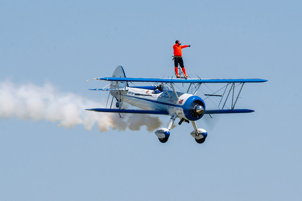 Photo by Rick Pepper - 2012 Mankato Air Show - Wing-walker Dave Kazian & stunt pilot Dave Dacy make a level pass