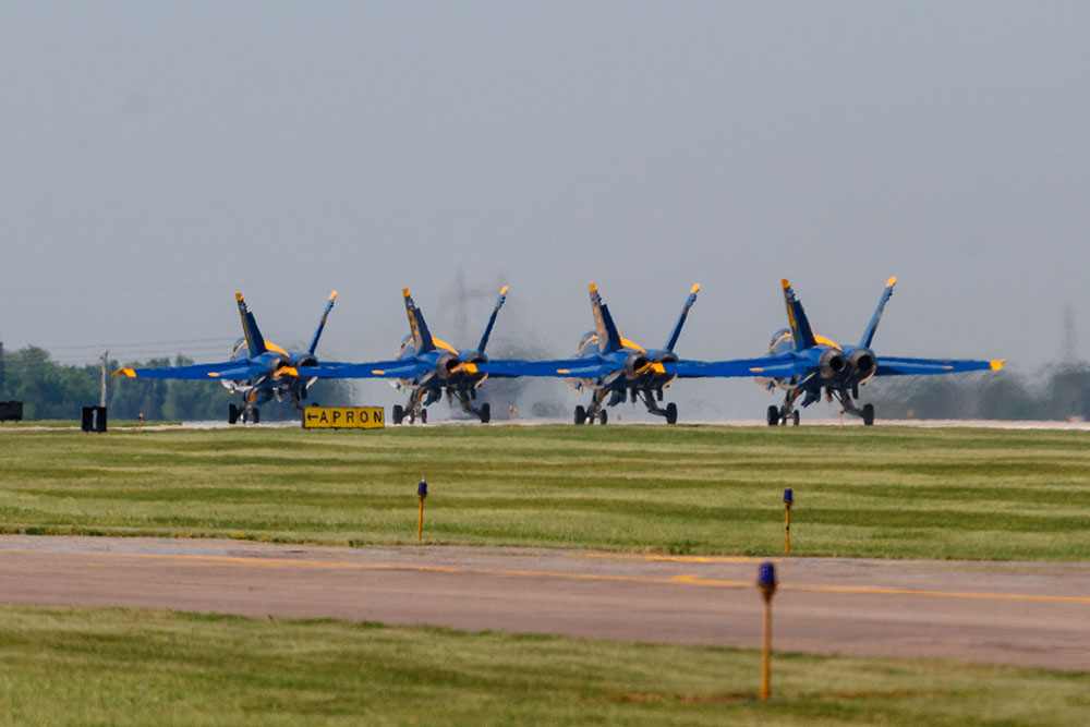 Photo by Rick Pepper - 2012 Mankato Air Show - Blue Angel aircraft #1-4 taxi to the end of the runway. Note the distortions from their super-heated jet turbine exhaust
