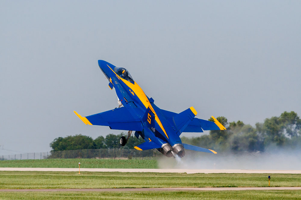 Photo by Rick Pepper - 2012 Mankato Air Show - The Blue Angel #5 aircraft (the lead solo) performs an abrupt, high speed take-off