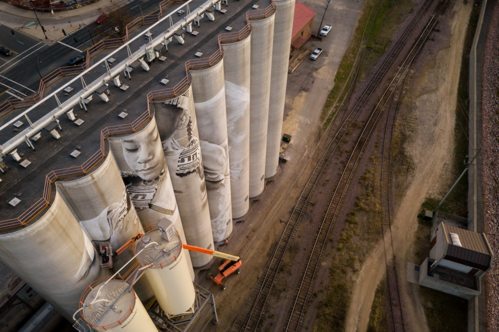 Photo by Rick Pepper - Aerial view of the in-progress Silo Art Project by Australian artist, Guido van Helten on the Ardent Mill grain silos at the gateway of Old Town, Mankato.