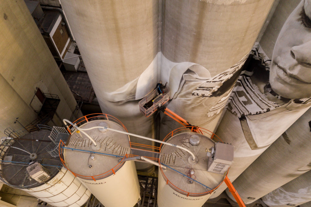 Photo by Rick Pepper - Aerial view Australian artist, Guido van Helten at work on the Ardent Mill grain silos.