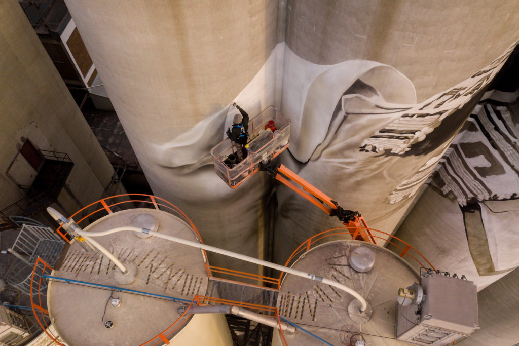 Photo by Rick Pepper - Aerial view Australian artist, Guido van Helten at work on the Ardent Mill grain silos.