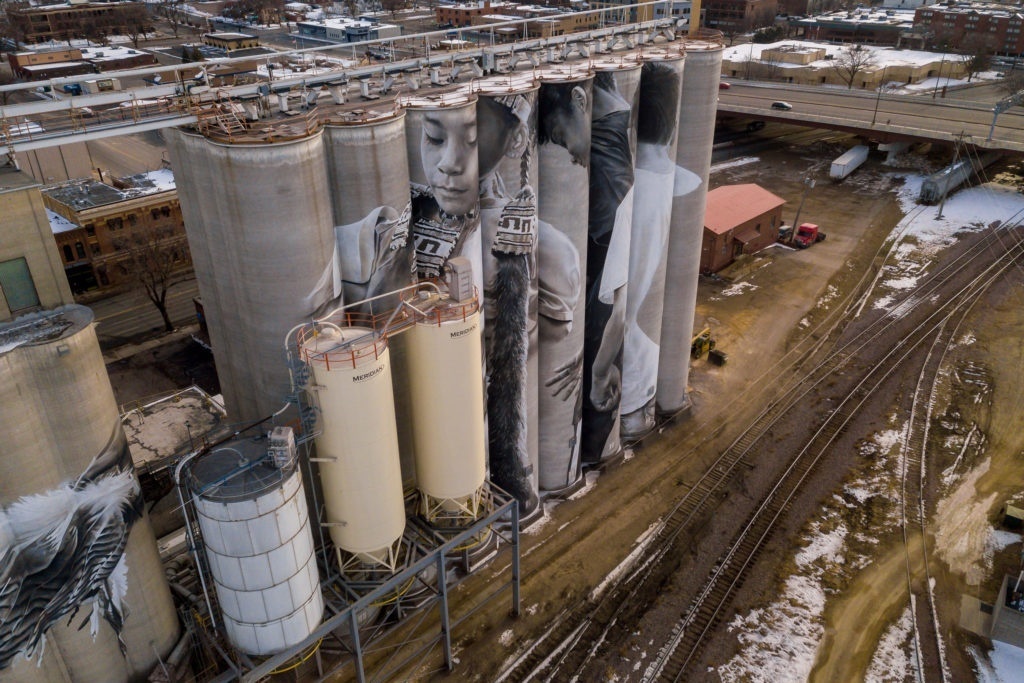 Photo by Rick Pepper - Aerial view of the in-progress Silo Art Project by Australian artist, Guido van Helten on the Ardent Mill grain silos at the gateway of Old Town, Mankato.