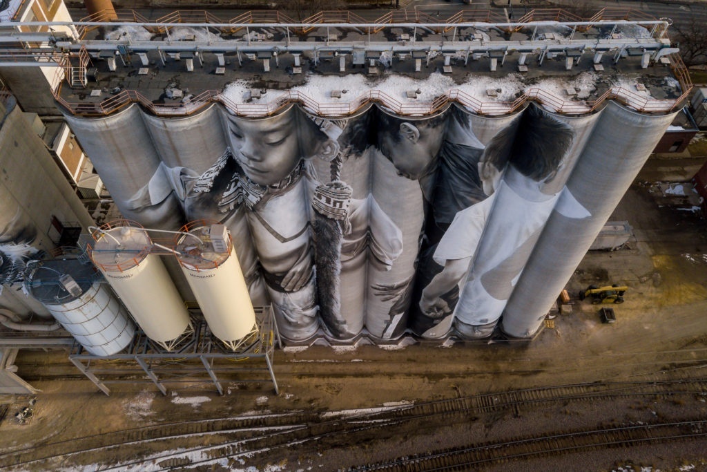 Photo by Rick Pepper - Aerial view of the in-progress Silo Art Project by Australian artist, Guido van Helten on the Ardent Mill grain silos at the gateway of Old Town, Mankato.