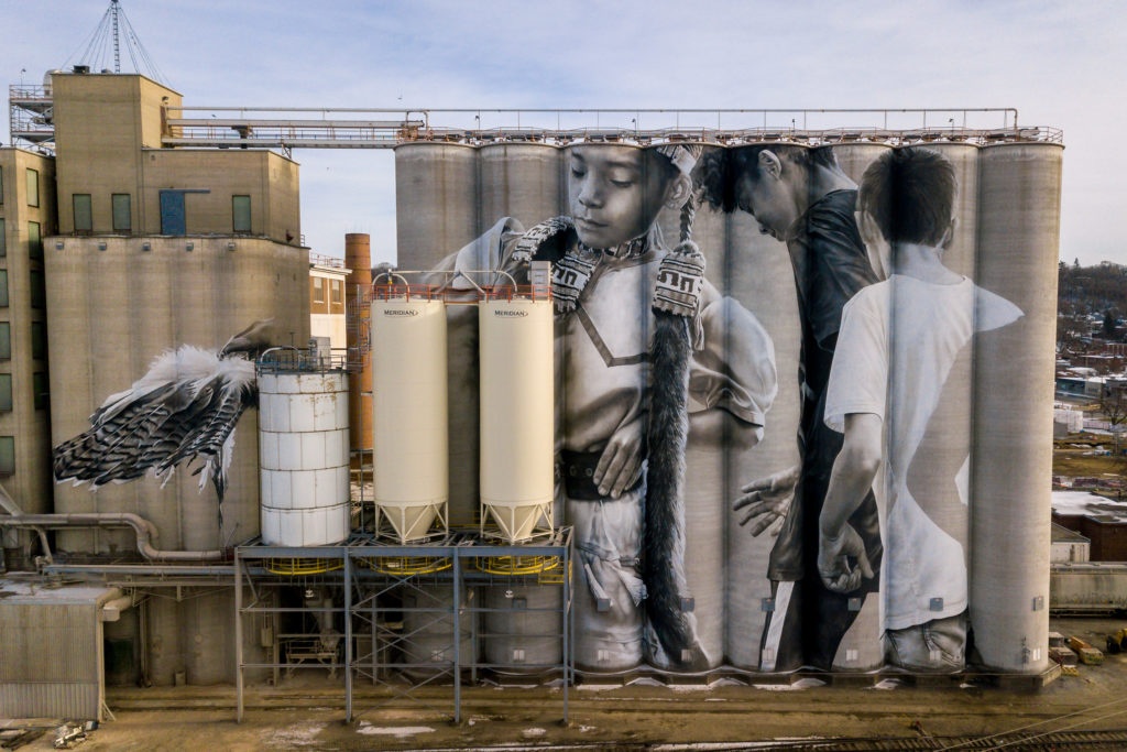 Photo by Rick Pepper - Aerial view of the in-progress Silo Art Project by Australian artist, Guido van Helten on the Ardent Mill grain silos at the gateway of Old Town, Mankato.