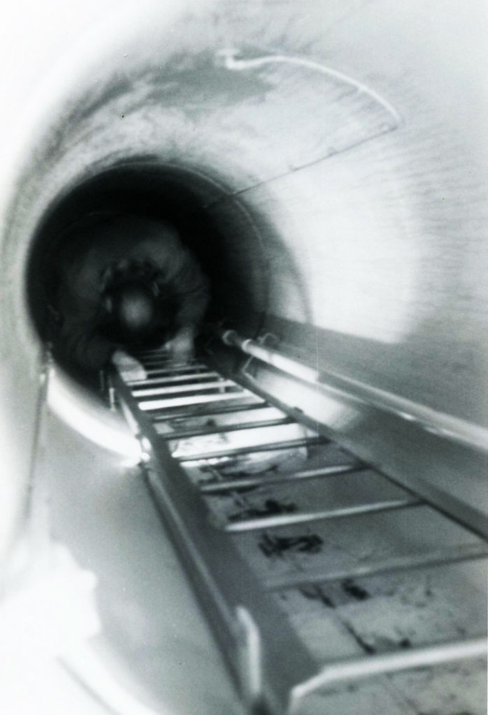 Photo courtesy of Bob Kreuzer - Cecil Jones of Kato Engineering takes the ladder to take a look at the room with the electric-powered pumps 20 feet below ground.