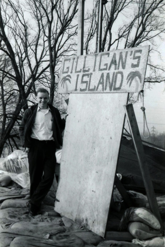 Photo courtesy of Bob Kreuzer - Lift Station volunteer Bob Kreuzer stands next to the sign naming North Mankato's own "Gilligan's Island" after the, then current, CBS television comedy show.