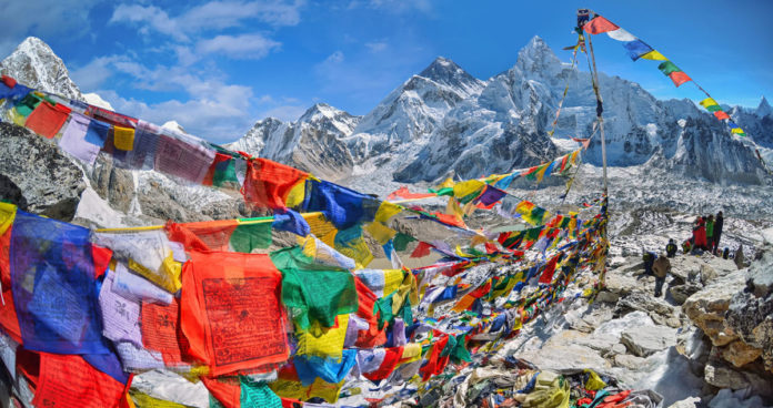 View of Mount Everest and Nuptse with buddhist prayer flags from kala patthar in Sagarmatha National Park in the Nepal Himalaya