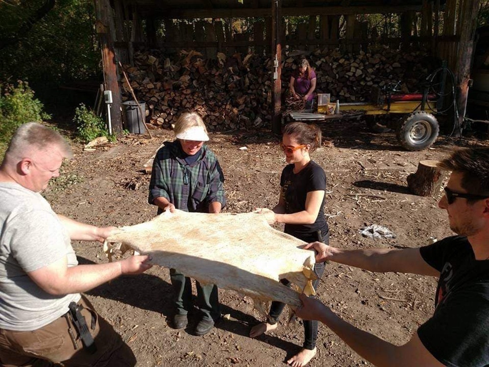 Submitted Photo - Students learning how to process a deer hide in the intermediate class at the Minnesota Primitive Skills and Survival School