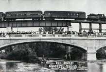 From History of the Red Jacket Valley by Julie A. Schrader - Panoramic view of the Red Jacket Bridge and Trestle by Mankato photographer, John R. Snow at the dedication of the bridge on August 22, 1911. Snow coaxed the train engineer into backing up so the camera could capture everything. He was credited with the first panoramic photograph taken in the Mankato area. Actually, the photograph is a composite of four photographs snapped from the same spot and then pieced together.