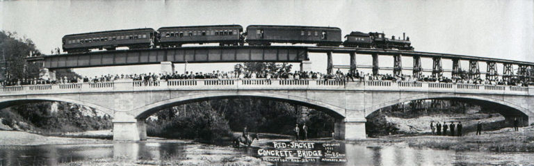 From History of the Red Jacket Valley by Julie A. Schrader - Panoramic view of the Red Jacket Bridge and Trestle by Mankato photographer, John R. Snow at the dedication of the bridge on August 22, 1911. Snow coaxed the train engineer into backing up so the camera could capture everything. He was credited with the first panoramic photograph taken in the Mankato area. Actually, the photograph is a composite of four photographs snapped from the same spot and then pieced together.