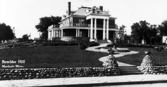 Submitted Photo - Schmidt Mansion, Mankato - It’s an interesting coincidence that the Marsh family home was located on top of a hill behind a slough (now the current West High School). Lovelace describes her house in Emily of Deep Valley as “a little house huddled against a low hill. It was old and weather-beaten” and had a “faded white picket fence.” The Marsh house was torn down in 1923 and an elegant house was built on the property by Oscar and Katherine Schmidt. The Schmidt Mansion remained in the family until 1958, when the YMCA acquired it for office space. The house was torn down in 1988 to make room for a new facility.
