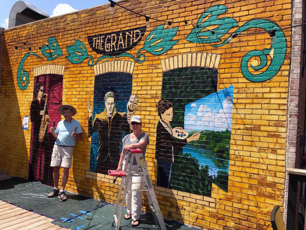Submitted Photo - Craig Nagel and Julie Johnson Fahrworth working on their mural for the New Ulm Grand Center for Arts and Culture