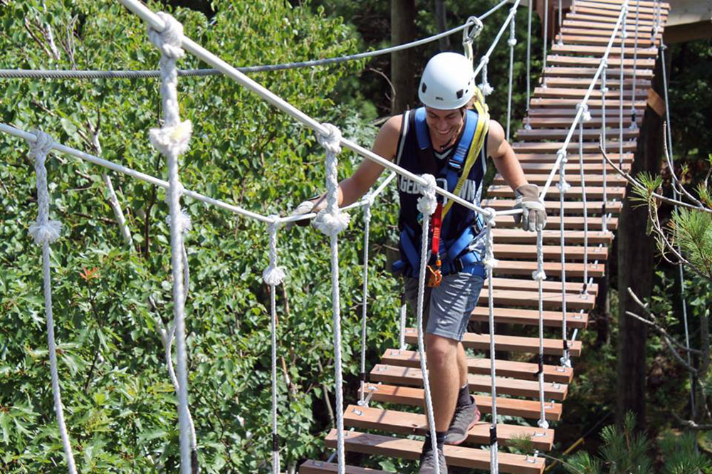 Submitted Photo - Participant at Kerfoot Canopy Tour near Henderson, Minnesota crosses the suspension bridge
