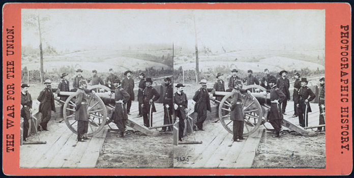 Photo from the Library of Congress - General William T. Sherman, center, leaning on the breach of a cannon, with his staff at Federal Fort No. 7 near Atlanta, Georgia in this stereopticon slide.