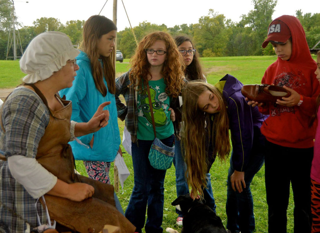 Submitted Photo - Pegeen Rozeske instructing kids on the art of shoemaking