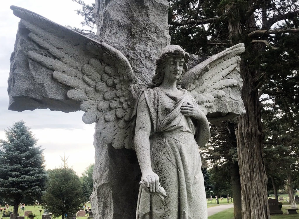 Photo by Mike Lagerquist - Caretaker Terry Miller says the stone for Fred Kron is the most photographed in the cemetery.