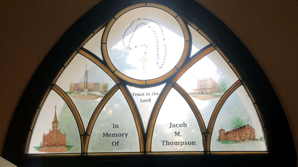 Photo by Mike Lagerquist - This window, donated by Charlie Thompson in honor of his son, Jacob, features the four Catholic churches that the cemetery originally served.