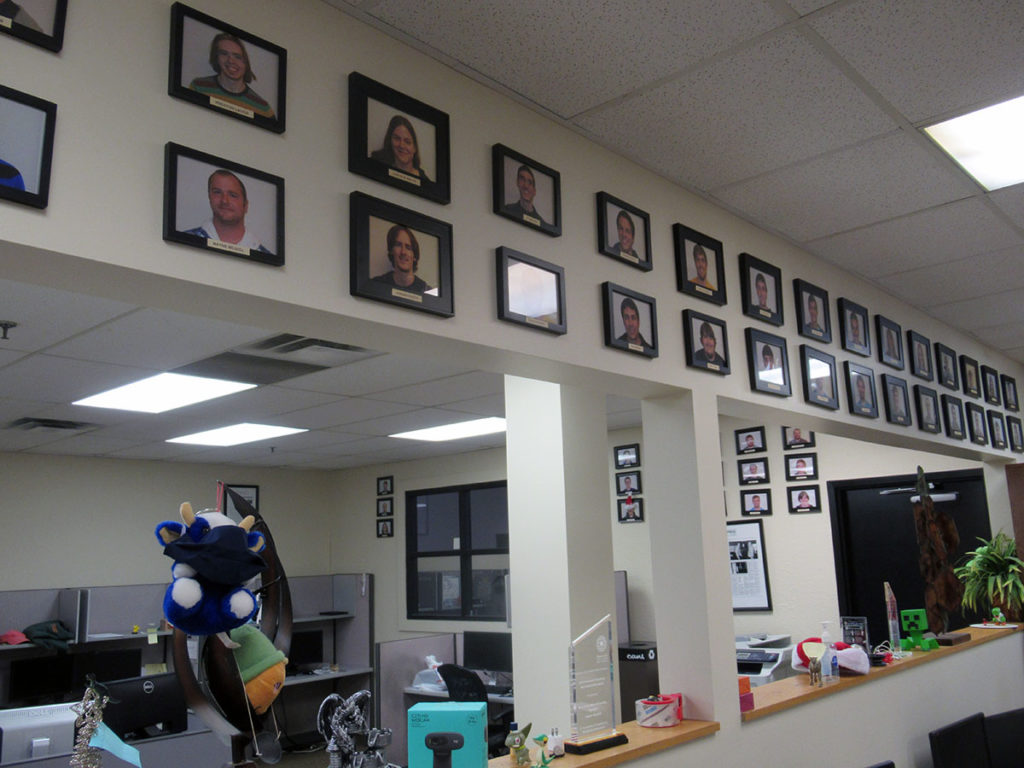 Photo by Grace Brandt - Photos of all of Maverick Software's former employees hang all over the office