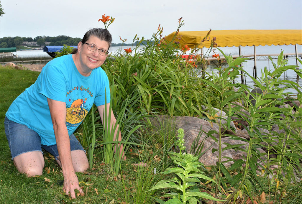 Submitted Photo - Karen Wright weeding her lakeshore planting.