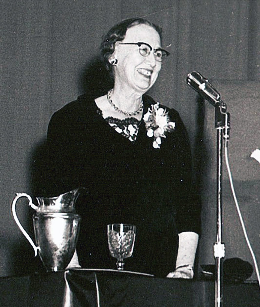 Photo courtesy of the Blue Earth County Historical Society - Maud Hart Lovelace speaks to a crowded audience in the Lincoln School auditorium, October 6, 1961