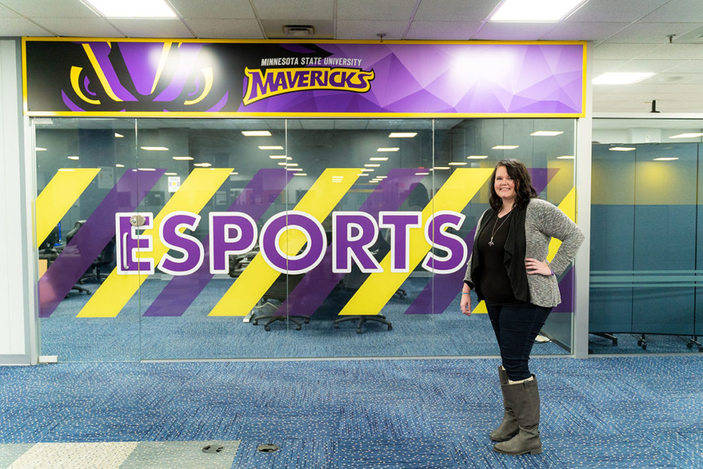 Submitted Photo - MSU Mankato's Varsity Esports Head Coach Jacquie Lamm in front of the team's new training facility