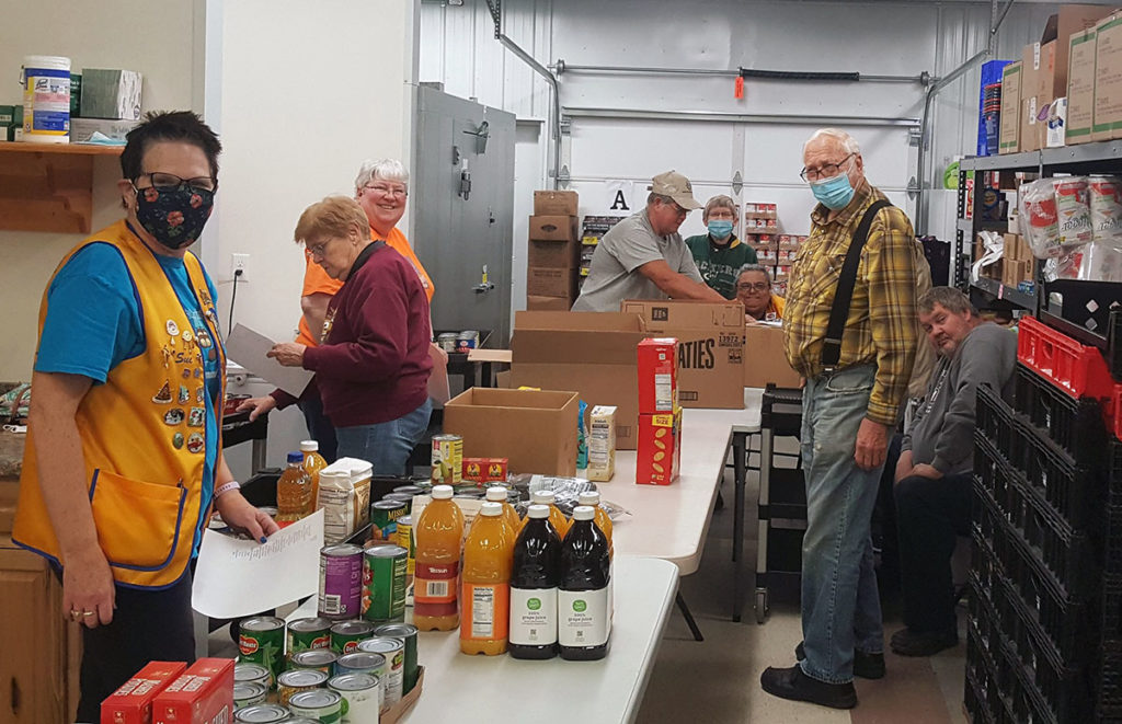 Submitted Photo - Members of the New Ulm Lion's Club as well a other community members preparing for the Mobile Food Shelf