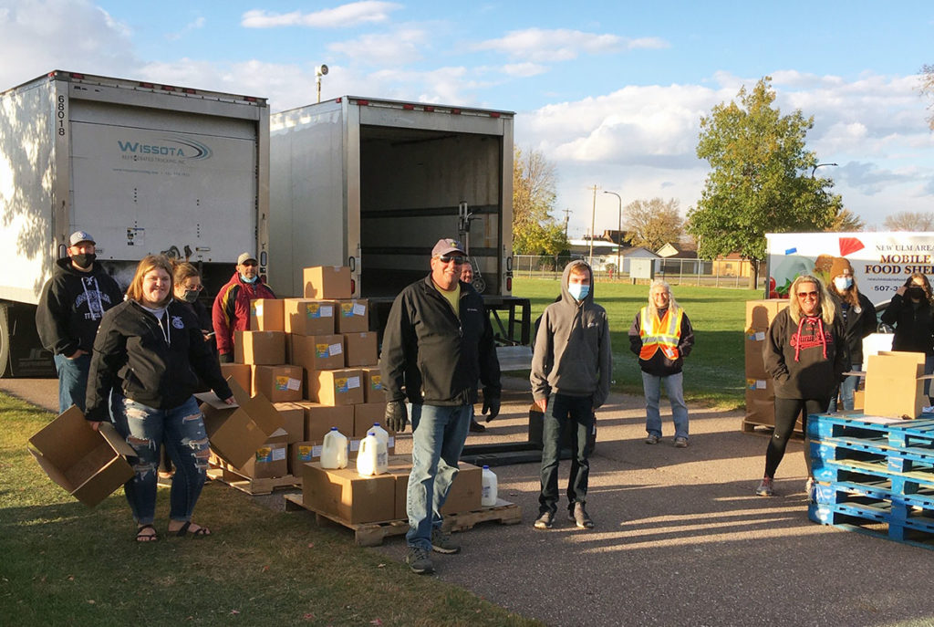 Submitted Photo - Members of the New Ulm Lion's Club as well a other community members loading the Mobile Food Shelf