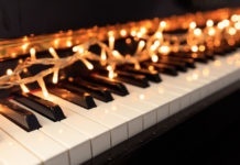 Christmas lights on a classical piano keyboard