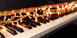Christmas lights on a classical piano keyboard