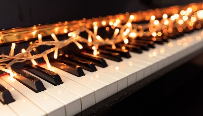 Christmas lights on a classical piano keyboard