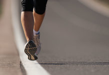 Fitness woman runner athlete running at road, working out cardio