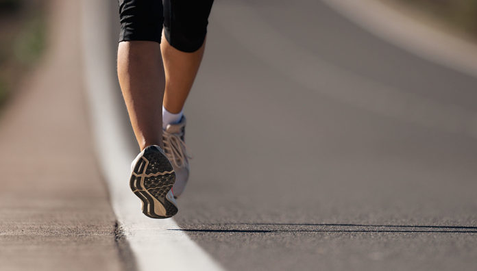 Fitness woman runner athlete running at road, working out cardio