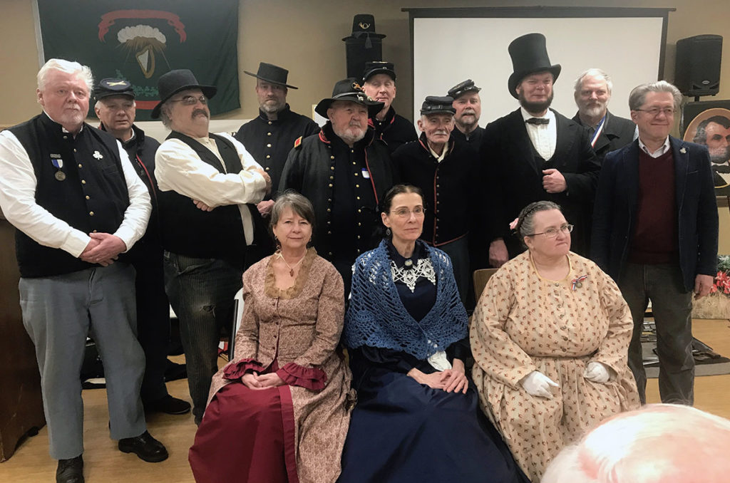 Photo by Julie Schrader - Presenters and living history actors at the 2019 Civil War Symposium. Back row, L-R: George Luskey, John Cain, Lonesome Ron, Joe Laechel, John Fritche, Bruce Olson, Ken Foss, Arn Kind, Bryce Stenzel, Daryl Hrdlicka, and Stephen Osman. Seated in front: Kate Roberts, Susan Hynes and Sandra Gilbert