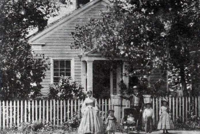 Photo Courtesy of Blue Earth County Historical Society - Home of Parsons King and Laura Johnson family in 1865. The house was built in 1854. L-R: Laura, Frank, Clarence, Parsons King, Charles and Julia.