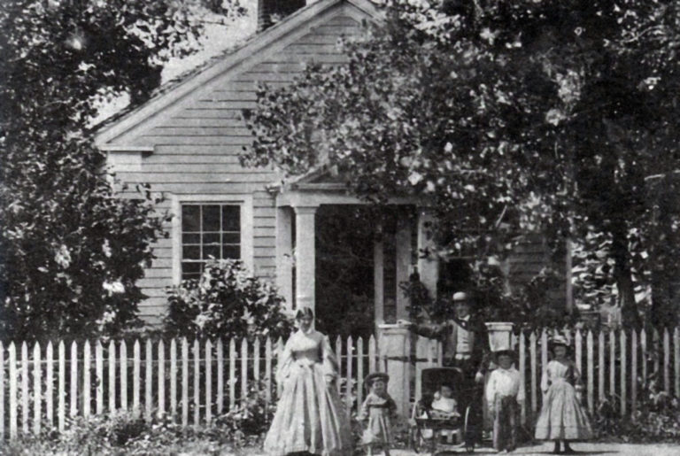 Photo Courtesy of Blue Earth County Historical Society - Home of Parsons King and Laura Johnson family in 1865. The house was built in 1854. L-R: Laura, Frank, Clarence, Parsons King, Charles and Julia.