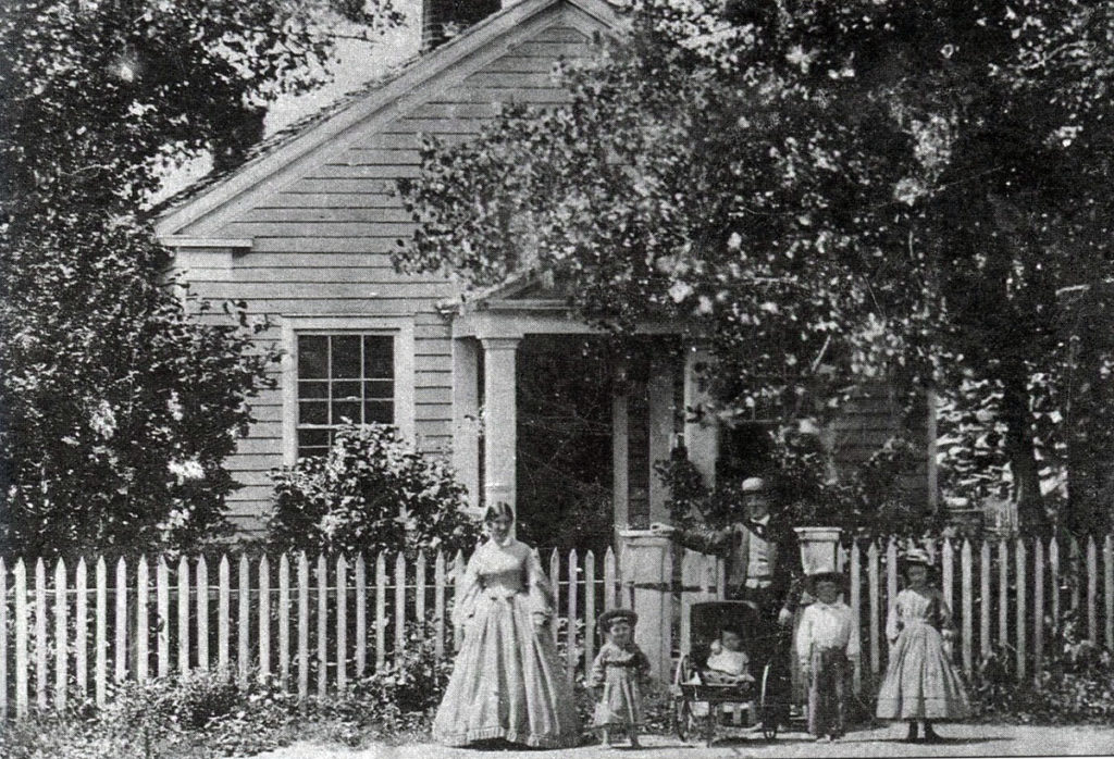 Photo Courtesy of Blue Earth County Historical Society - Home of Parsons King and Laura Johnson family in 1865. The house was built in 1854. L-R: Laura, Frank, Clarence, Parsons King, Charles and Julia.