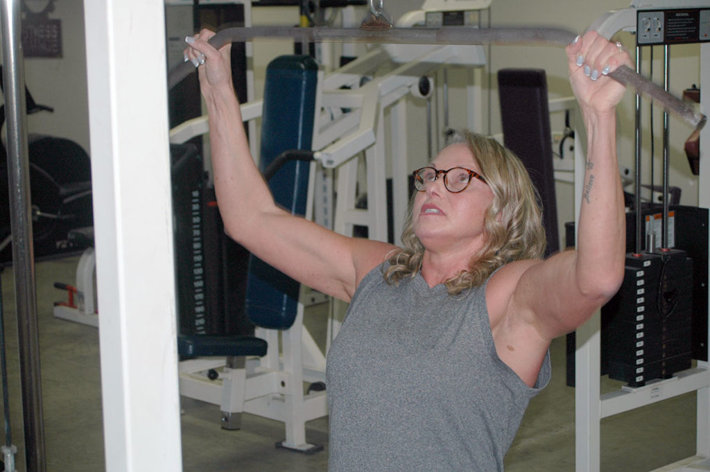 Photo by Don Lipps - Jo Radlinger of Jo's Fitness Garage busy with lat pull-downs