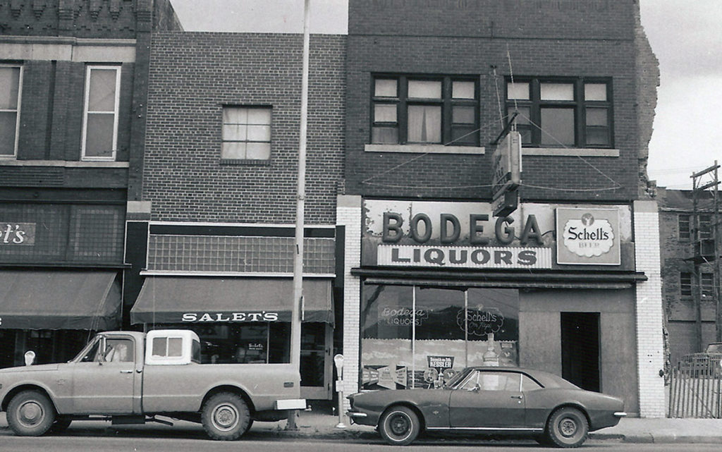 Photo Courtesy Blue Earth County Historical Society — With the wrecking ball approaching, the Bodega Bar is the only thing standing between life and death for the Salet’s “small store.”