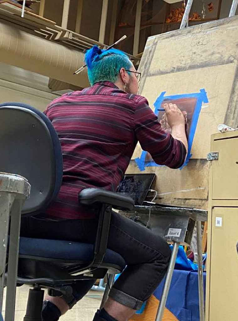 Photo by Sage Kiefer - Vincent Kenobbie at an easel in the Gustavus Adolphus art building