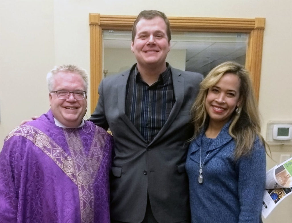 Submitted Image – Father Tim Biren, Garrett Steinberg and his wife, Ana, in St. Charles, March 2020.