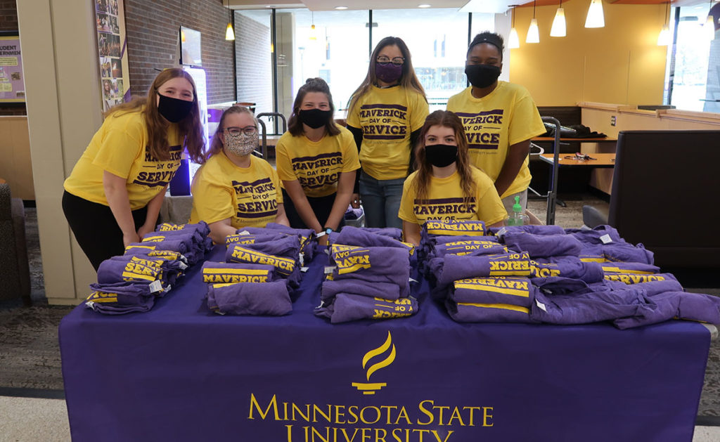 Photo by Meredith Maxwell - Mavs in Action student leaders handing out free t-shirts during check-in.